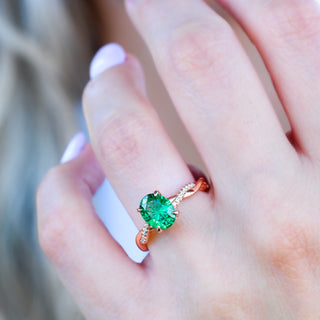 Sophia fireworks cut emerald ring in rose gold worn on a model's hand