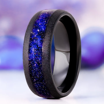 Starry Night sandblasted men's wedding band in black tungsten, 8mm, standing view showing the glittering blue galaxy inlay and matte sandblasted finish