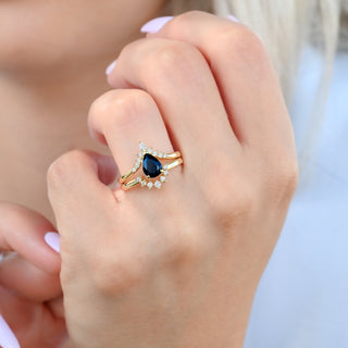Starry Night pear ring set in yellow gold worn on a model's hand