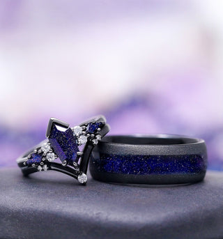 Two rings with blue gemstones on a gray surface with a blurred purple background