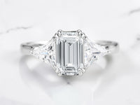 Three stone engagement ring by Aquamarise shown in a ring style banner