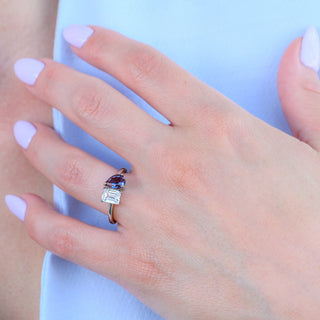 Toi et moi alexandrite engagement ring worn on a model's hand