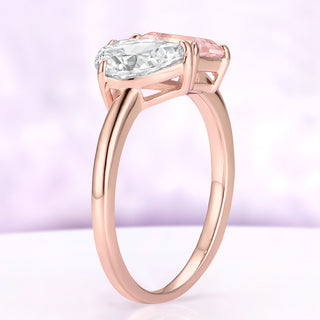 Angled close-up of the Toi Et Moi ring in rose gold with the pear moissanite and cushion morganite set side by side