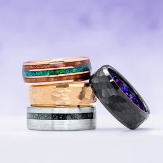 Three unique rings with different designs and colors on a light purple background