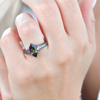 Victorian Gothic mystic topaz filigree engagement ring in black ruthenium worn on a model's hand