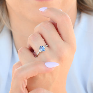 Violet hexagon lab sapphire engagement ring worn on a model's hand