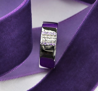 Viridian Leaf & Amethyst Men's Wedding Band in Sterling Silver (8mm) standing on a purple ribbon
