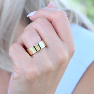 Viridian leaf and black onyx 8mm wedding band in yellow gold vermeil worn on a hand