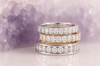Stack of diamond rings on a soft purple background