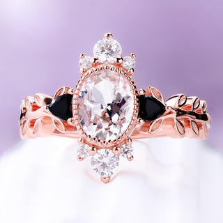 Front view of the white sapphire and black onyx leaf engagement ring in rose gold vermeil, oval center with trillion onyx sides and white accents