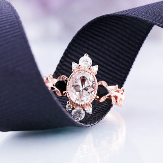White sapphire and black onyx leaf ring in rose gold vermeil resting on a black ribbon, showing the carved leaf band