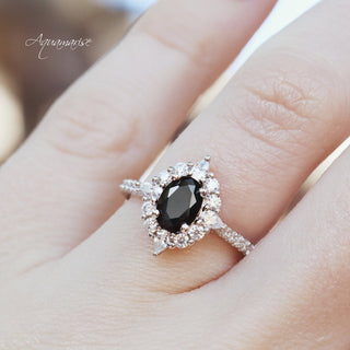 Astra Black Onyx Engagement Ring in Sterling Silver by Aquamarise featuring an oval black onyx center surrounded by sparkling white stones on a sterling silver band.