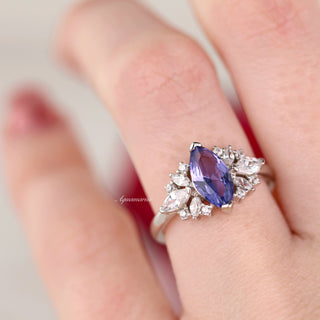 Adeline Marquise Cut Tanzanite Ring in Sterling Silver by Aquamarise, featuring a marquise violet tanzanite with mixed pear and round white stones on a polished sterling silver band.